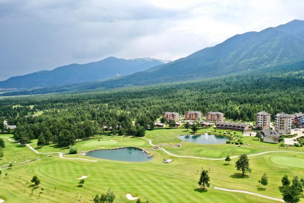 an aerial view of a golf course with two ponds at Spacious penthouse chalet apartment in Pirin Golf and Country Club in Razlog