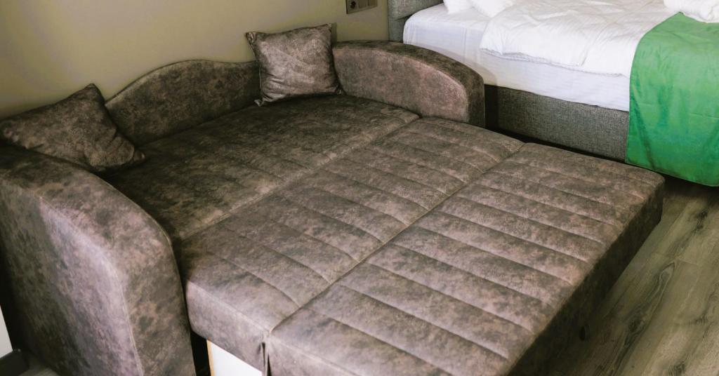 Postel nebo postele na pokoji v ubytování Aybek Ratio Hotel