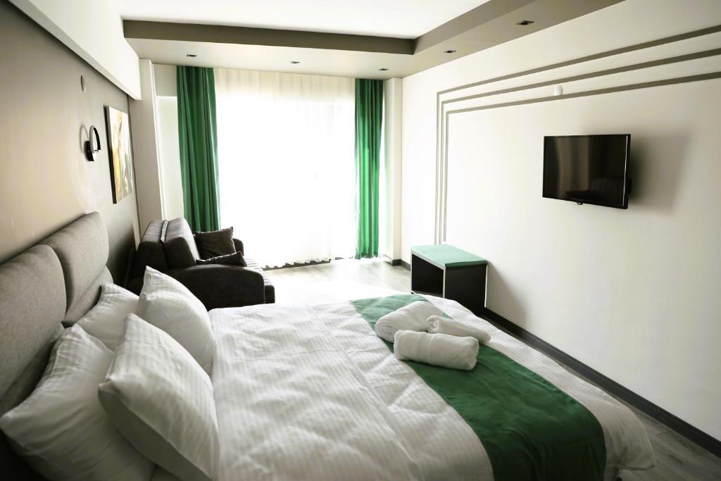 Postel nebo postele na pokoji v ubytování Aybek Ratio Hotel