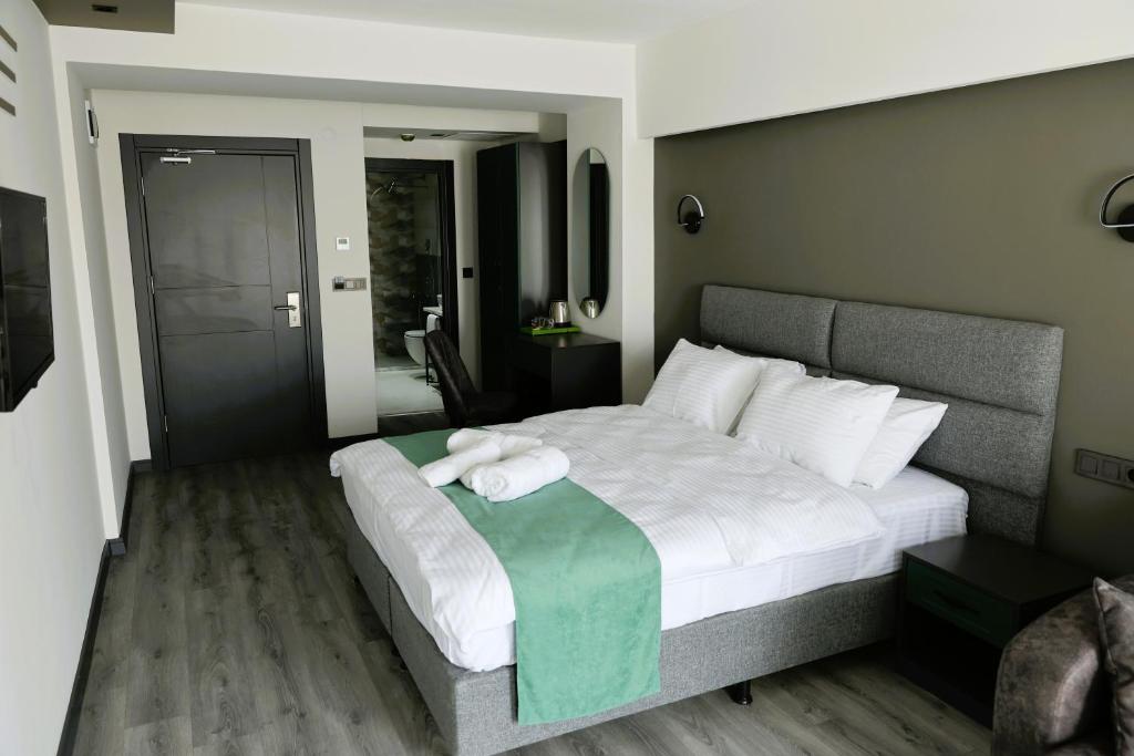 Postel nebo postele na pokoji v ubytování Aybek Ratio Hotel