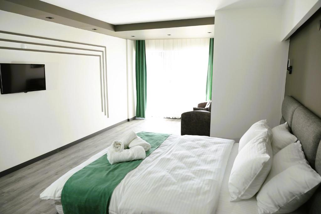 Postel nebo postele na pokoji v ubytování Aybek Ratio Hotel
