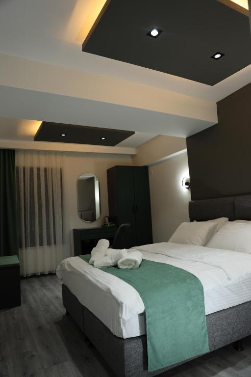 Postel nebo postele na pokoji v ubytování Aybek Ratio Hotel