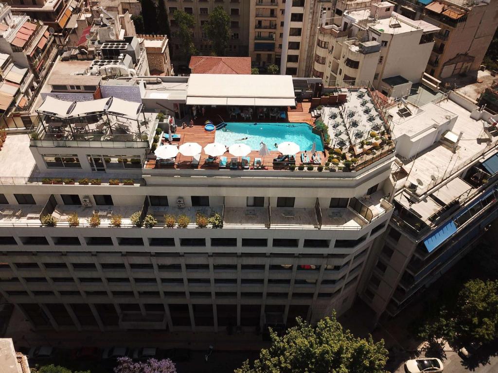 an overhead view of a building with a swimming pool at Novotel Athens in Athens