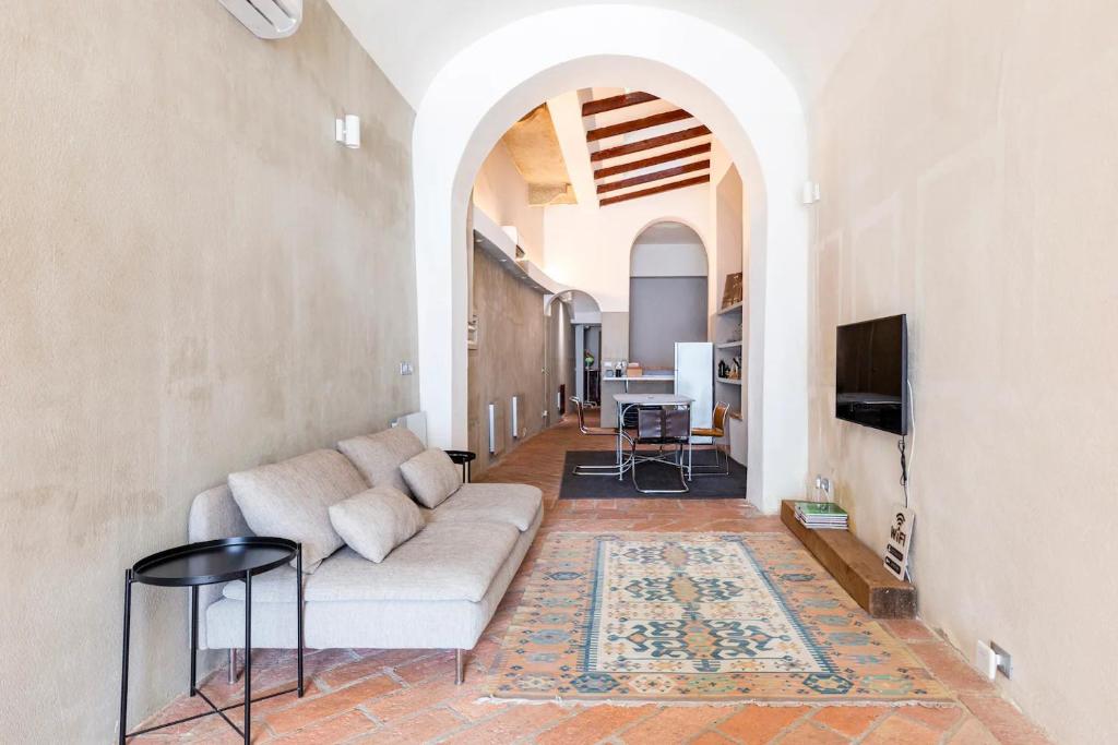 a living room with a couch and a tv at Loft 33 in Piacenza