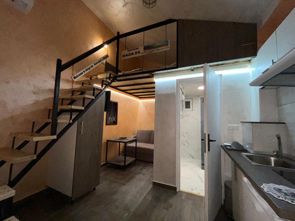 a small room with a staircase and a kitchen at APARTMAN OAZA 24 in Surčin