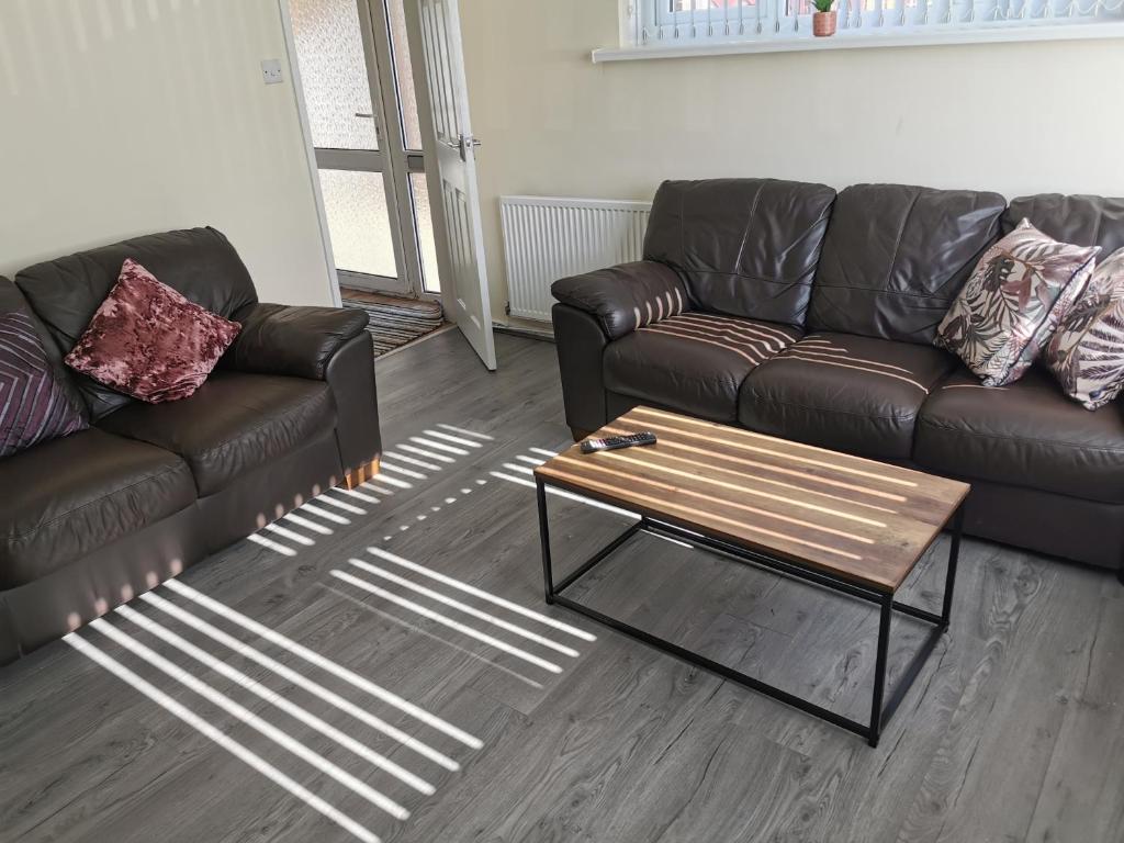 a living room with a couch and a coffee table at Stunning 3 Bedroom 5 beds House in Wolverhampton in Wolverhampton