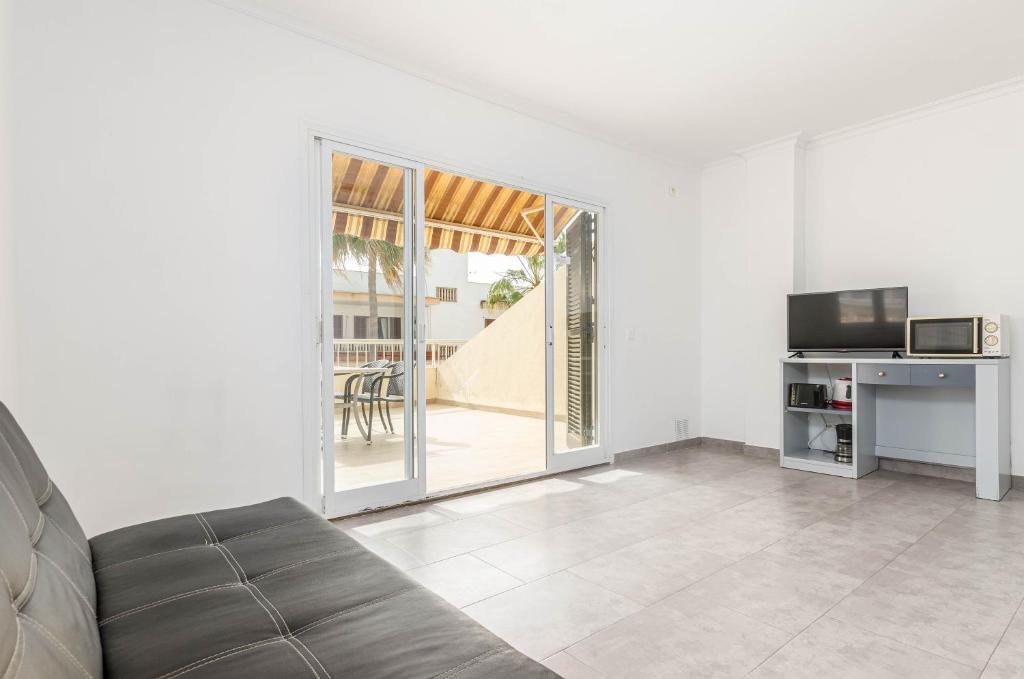 Televízia a/alebo spoločenská miestnosť v ubytovaní Acapulco Apartments