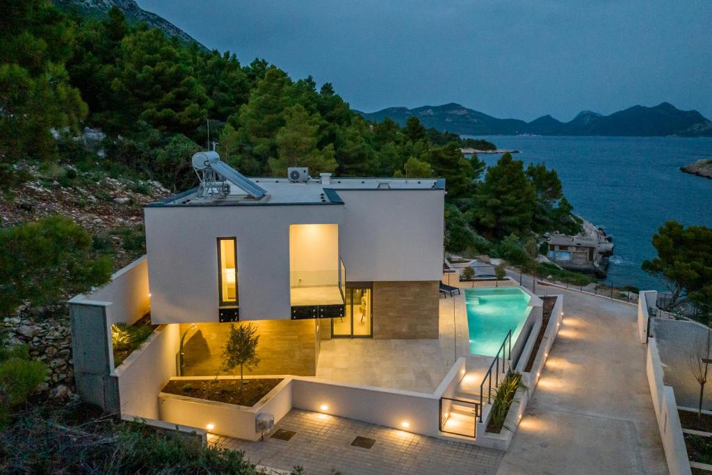 a house with a view of the water at Villa Luce Pelješac in Potomje