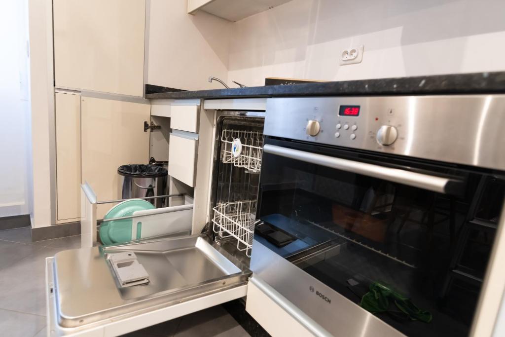 a kitchen with an oven with a dish rack at We Love Paris - Private Apartment in Vitry-sur-Seine