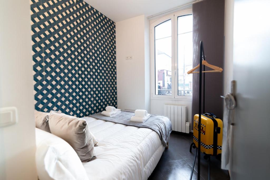a small room with a bed and a window at We Love Paris - Private Apartment in Vitry-sur-Seine