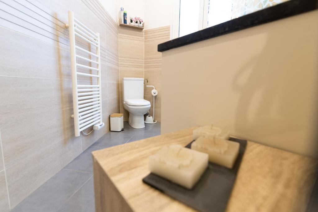 a bathroom with a sink with a toilet in it at We Love Paris - Private Apartment in Vitry-sur-Seine