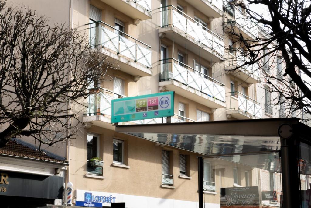 a street sign in front of a building at We Love Paris - Private Apartment in Vitry-sur-Seine
