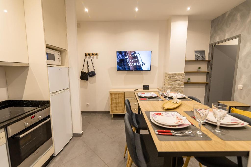 a kitchen and dining room with a table and chairs at We Love Paris - Private Apartment in Vitry-sur-Seine