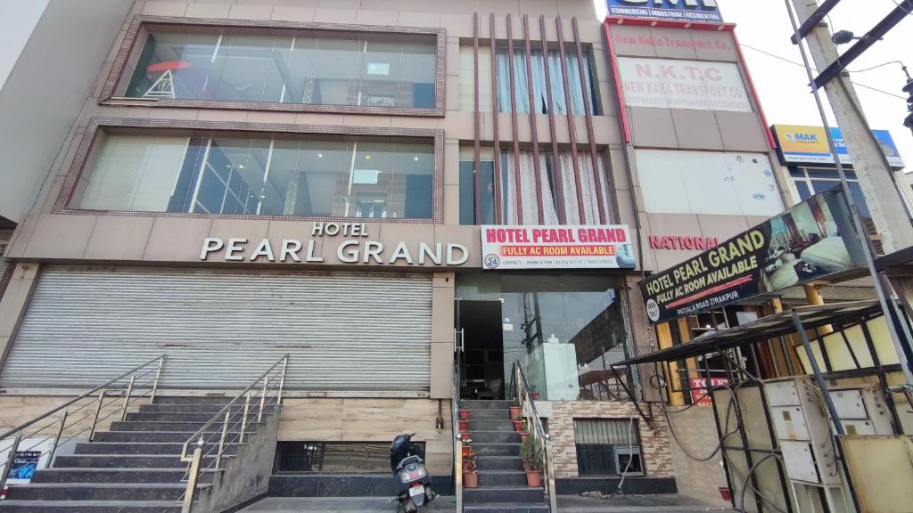 a man on a motorcycle in front of a building at Hotel Pearl Grand Prime in Karnal