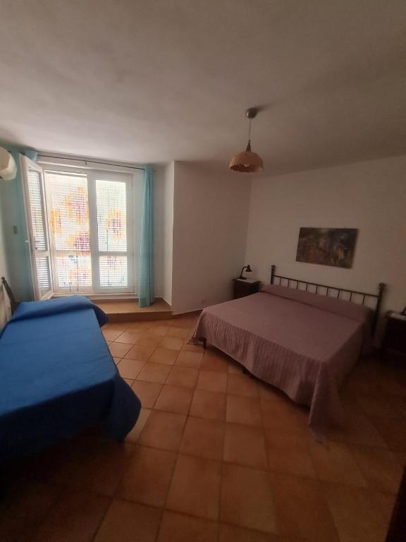 Postel nebo postele na pokoji v ubytování Le Case dei Pescatori - La Costa del Sole