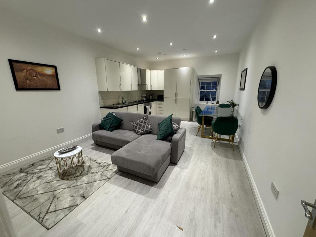 a living room with a couch and a kitchen at Extra Large 1 bedroom Apartment in Walton in Walton-on-the-Naze