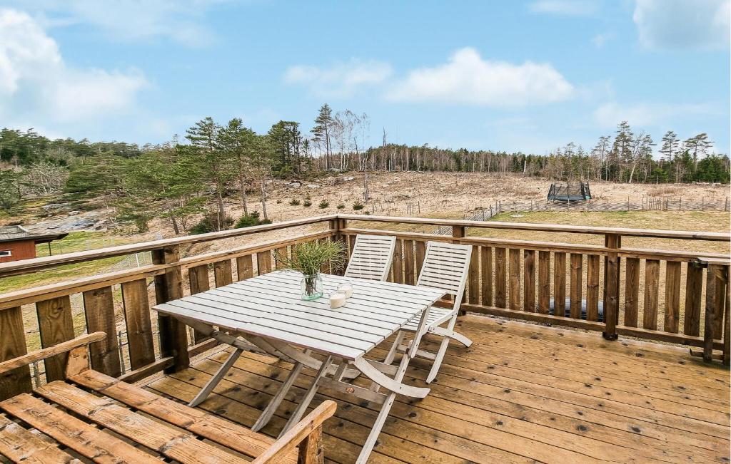a wooden deck with a table and chairs on it at Awesome Apartment In Ljungskile With Wifi in Ljungskile