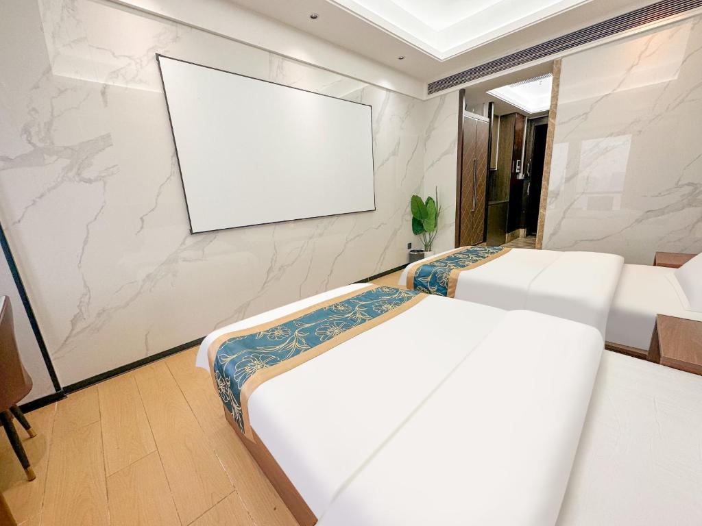Postel nebo postele na pokoji v ubytování Xingyin Cloudy Hotel Guangzhou Changgang Subway Station - Free Shuttle Bus to Canton Fair Complex During Canton Fair Period