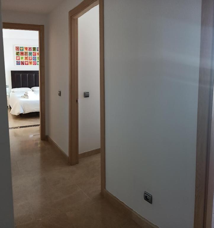 A bed or beds in a room at Lovely apartment with pool & sea views - Marina Del Castillo 2129