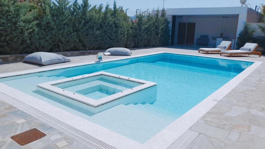 a swimming pool in the middle of a yard at One Bedroom Pool House by Olivujoj in Anavyssos