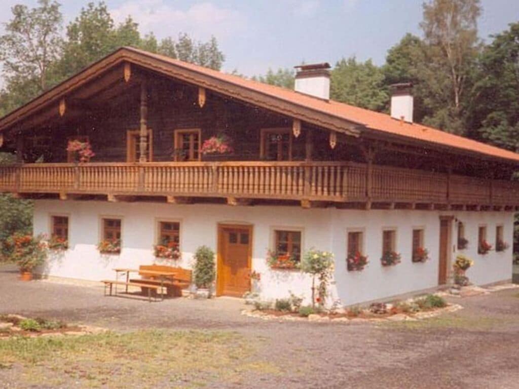 a large white house with a wooden roof at 2 holiday guesthouse Posthof in Waldmünchen