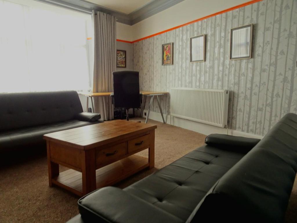 a living room with a couch and a coffee table at Earthling 1, Apartment in Blackpool