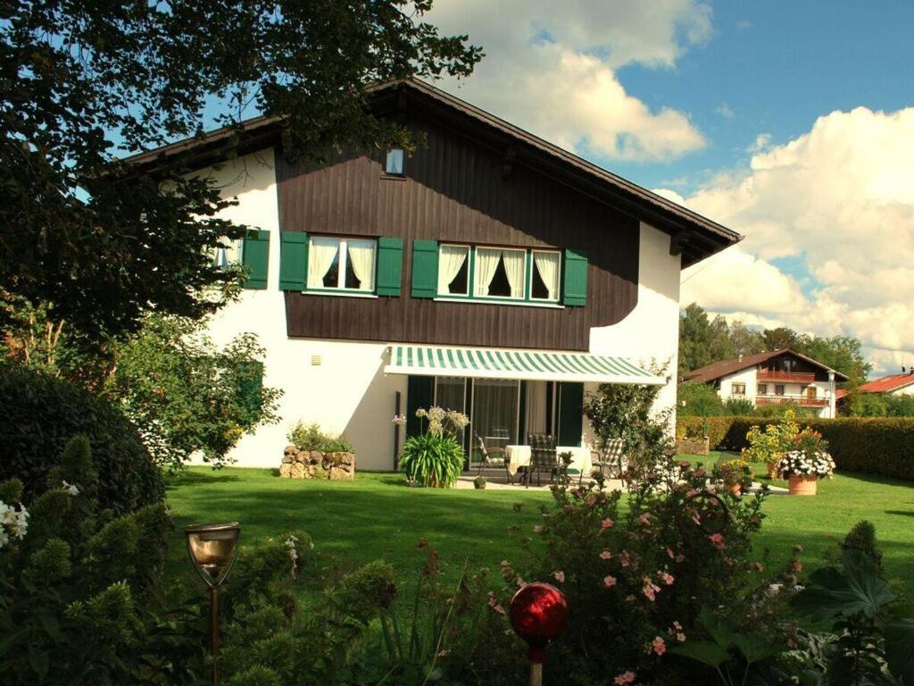 a large house with a green and white at Haus Jörg Sosna Modern retreat in Bad Bayersoien