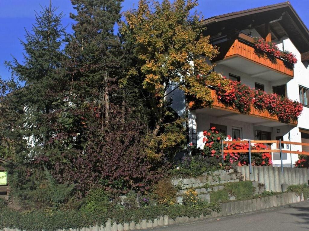 a house with flowering plants on the side of it at Haus Nett Modern retreat in Stiefenhofen