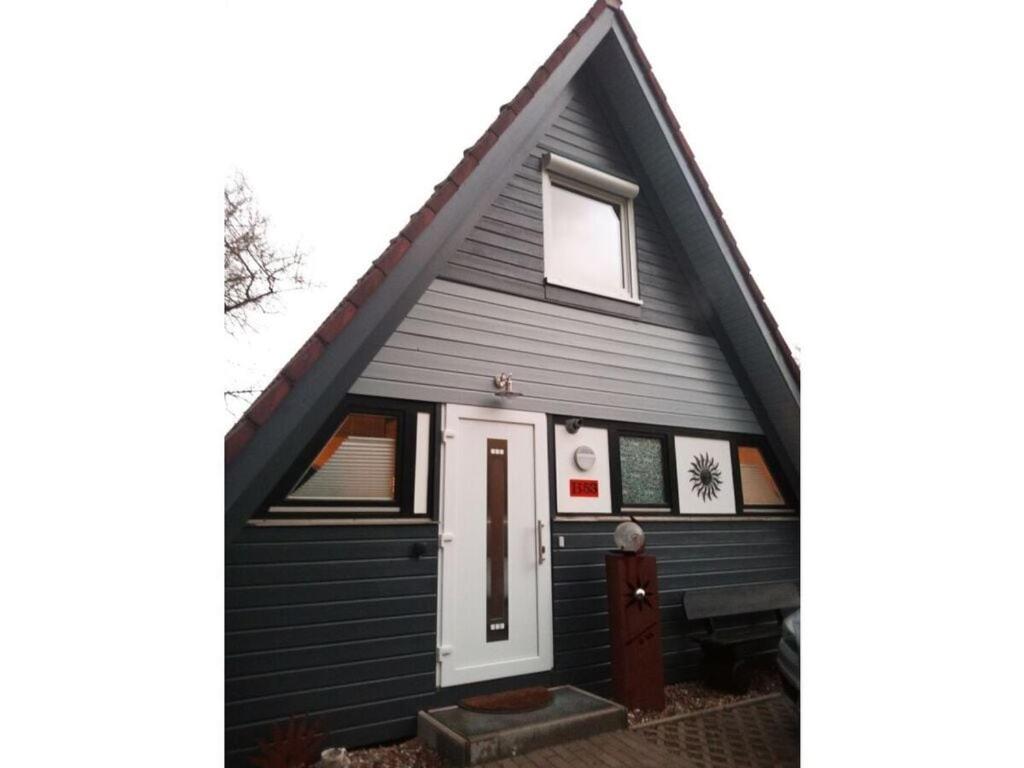 a black house with a white door and a window at Sunshine Modern Retreat in Ronshausen