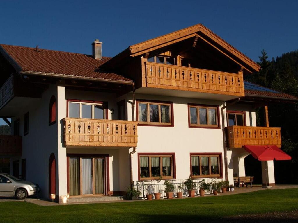a large house with a balcony on top of it at Partnachklamm Modern retreat in Garmisch-Partenkirchen