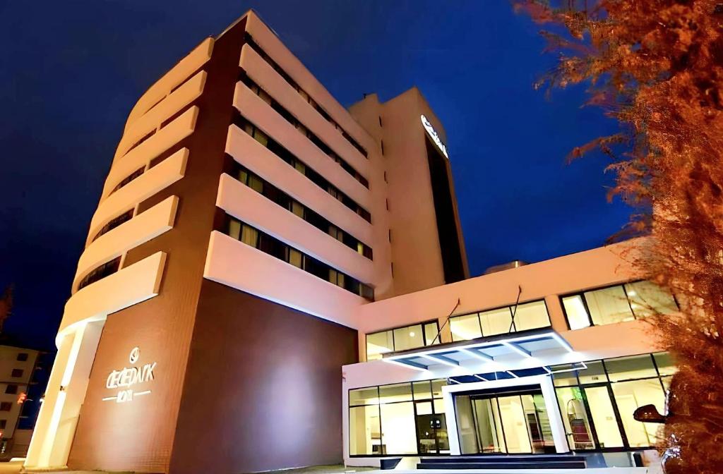 a large building with lights on at night at Dedepark Hotel in Eskisehir