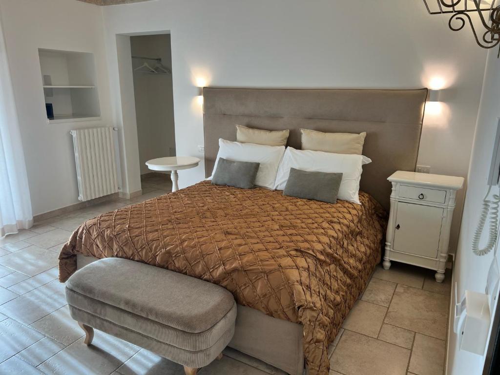 a bedroom with a large bed and a chair at Sogno D'Epoca 1822 in Monopoli
