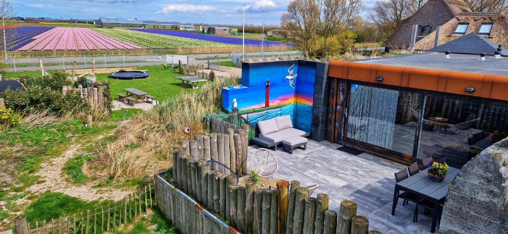 a house with a rainbow painted on the side of it at Vakantiehuis De Bunker in Julianadorp