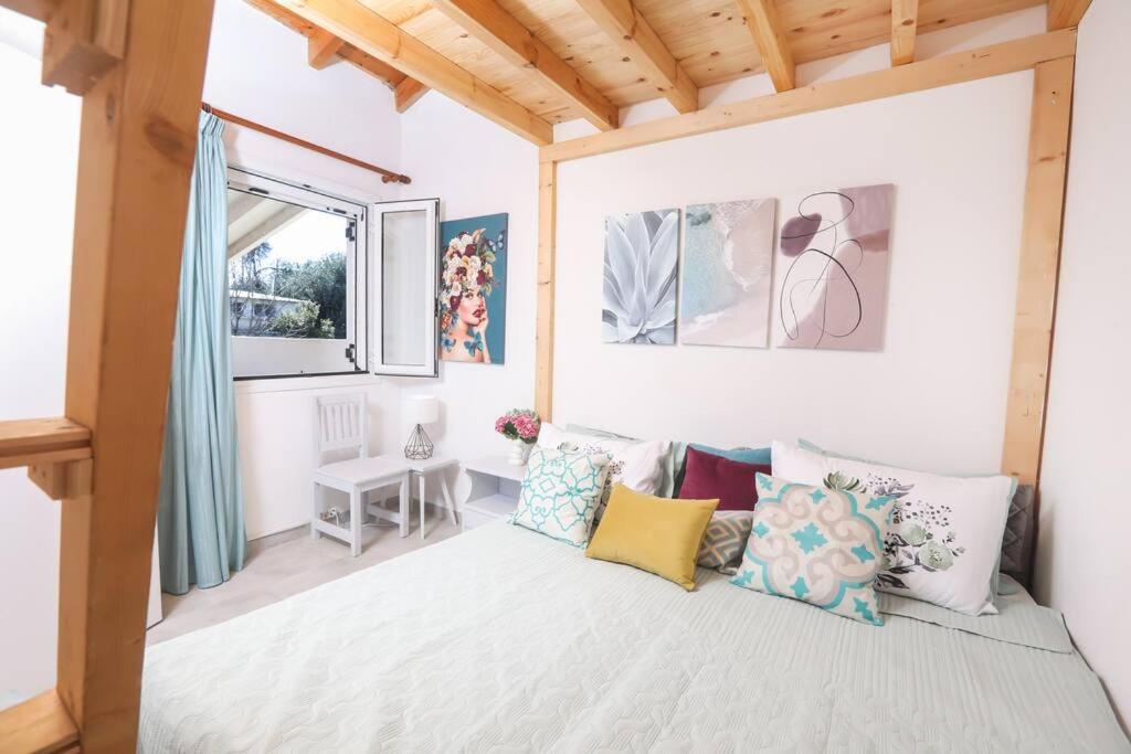 a bedroom with a large bed with pillows at Casa Niovi, Acharavi in Acharavi