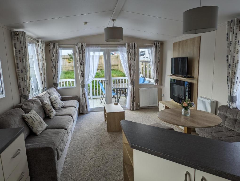 a living room with a couch and a table at 11 Meadow View in Newquay