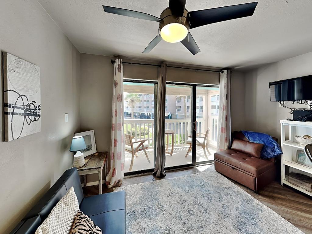 a living room with a ceiling fan and a couch at Villa Del Sol #2138 in Corpus Christi