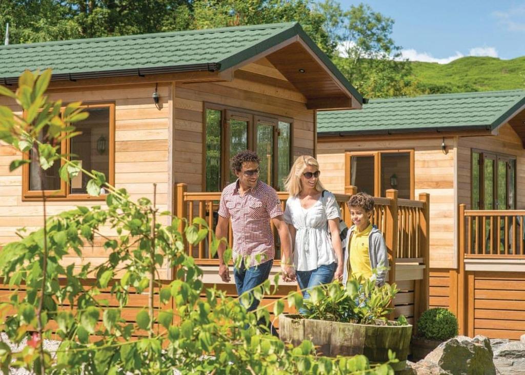 a family walking out of a tiny house at Crake Valley in Torver