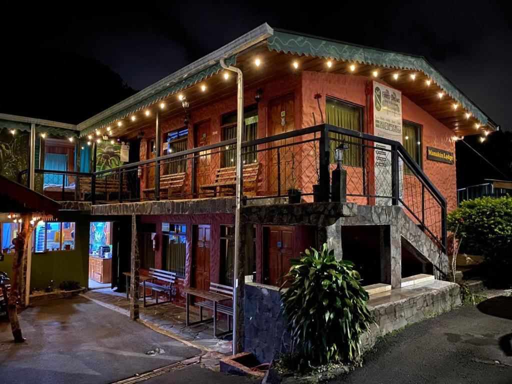 a building with a balcony with lights on it at Manakin Lodge, Monteverde in Monteverde Costa Rica