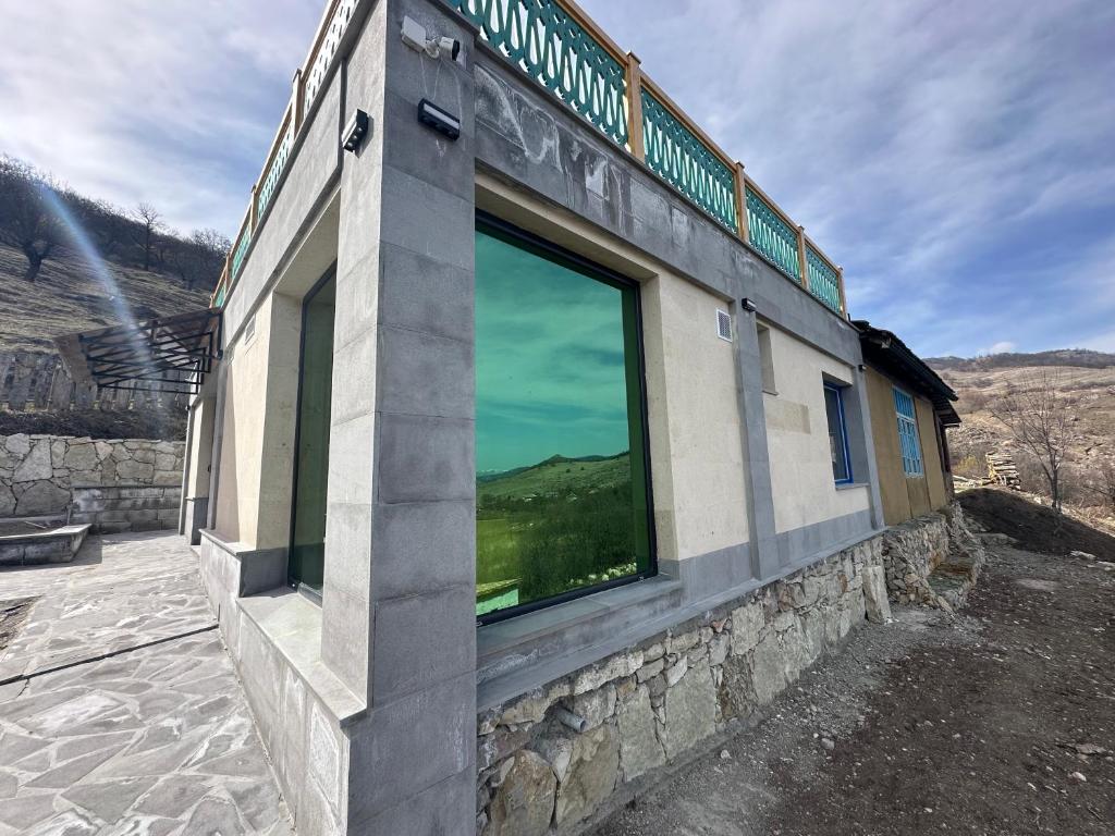 a building with a large window on the side of it at Hovk Farms in Dilijan