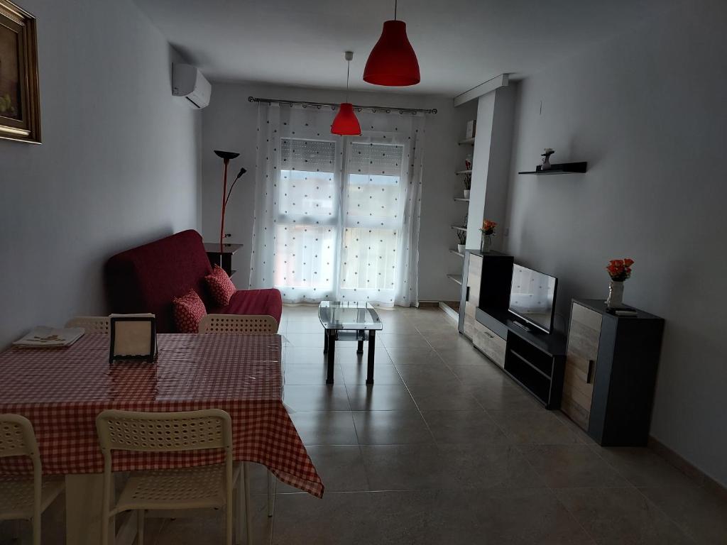 a living room with a table and a television at Piso Vinaros in Vinarós