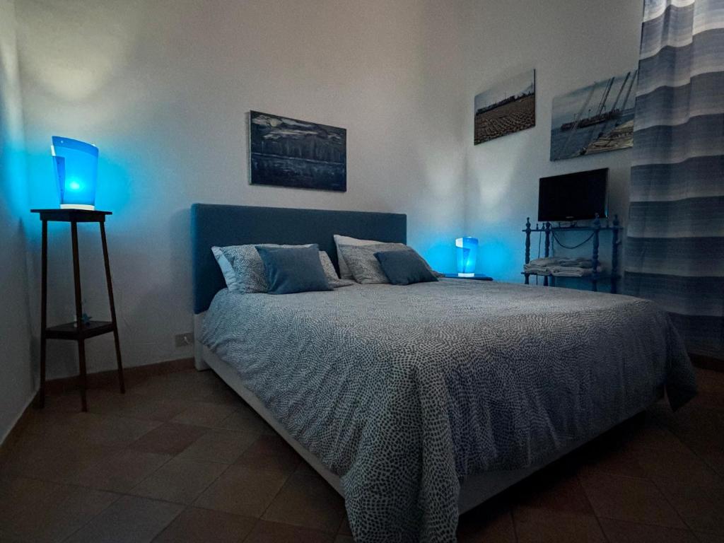 a bedroom with a bed with blue lights on it at Casa Vacanze Penelope in Trapani