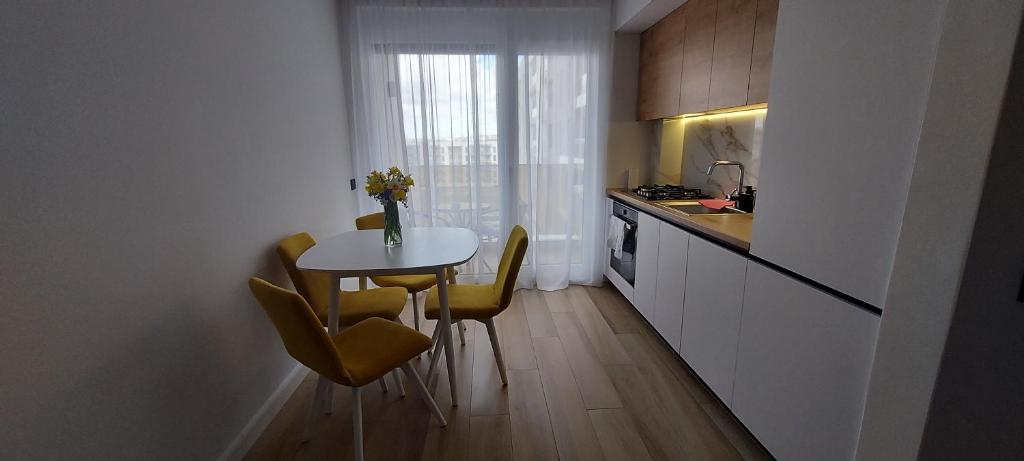 a small kitchen with a small table and chairs at SIA Studio in Oradea