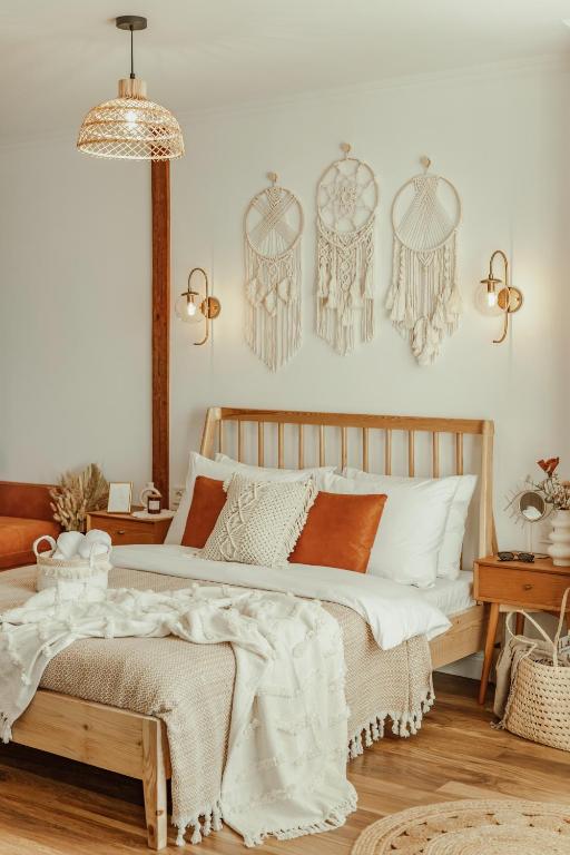 a bedroom with a bed with white sheets and orange pillows at BOHORIA Studio Apartments - Old Town in Veliko Tŭrnovo