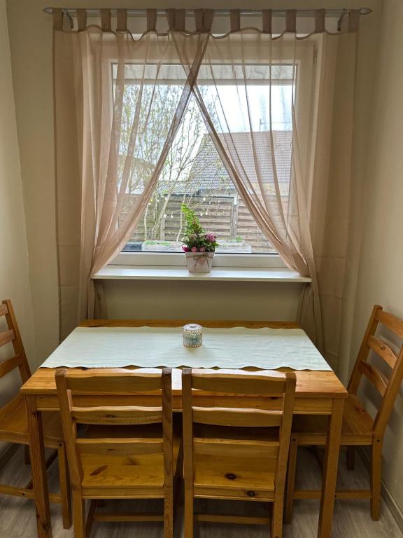 a table and chairs in front of a window at Ferienwohnung Steinebach 
