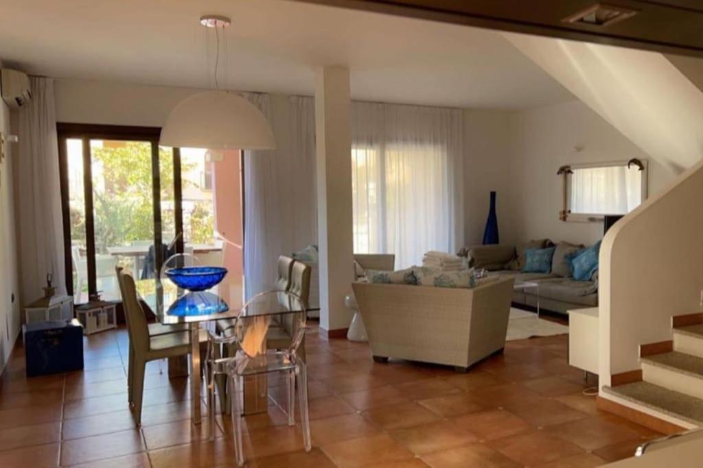 a living room with a couch and a table at Villa a 2 piani vicino al mare in Villasimius