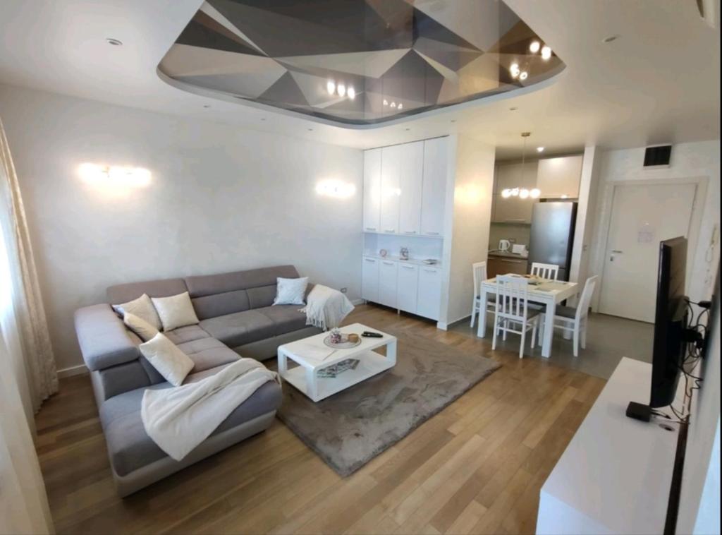 a living room with a couch and a table at Ada Luxury Apartment in Čukarica