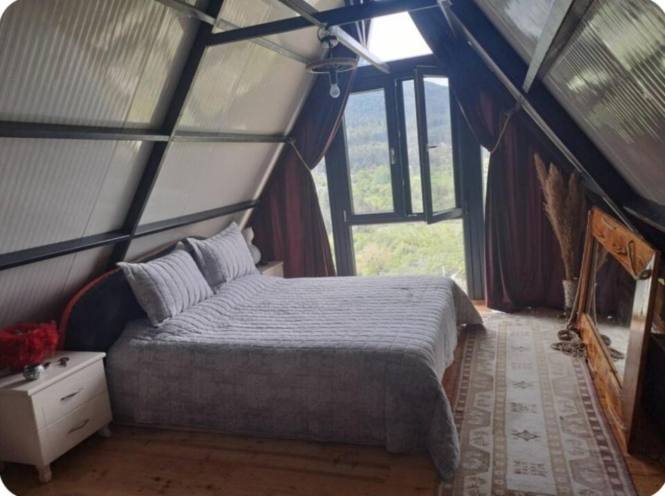 a bedroom with a bed in a tent at Canerbey Çiftlik in Ovacık