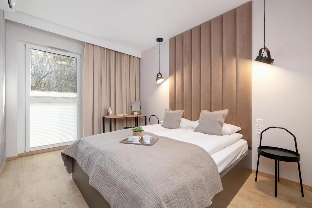 a hotel room with a bed and a window at Bright Apartment in Kraków with Garden, Air Conditioning, Parking and Desk by Renters Prestige in Kraków