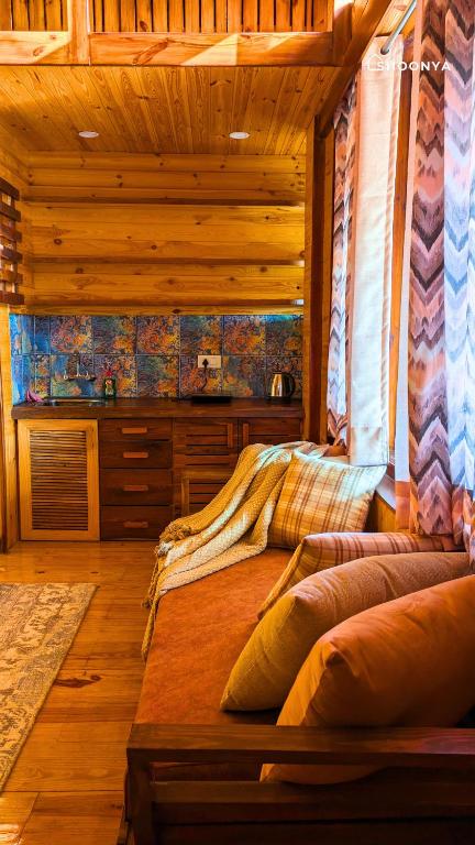 a bedroom with a bed in a log cabin at Shoonya Mukteshwar in Mukteswar