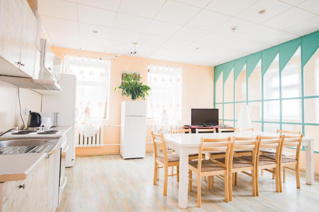 a kitchen and dining room with a table and chairs at Maria Hostel in Valga